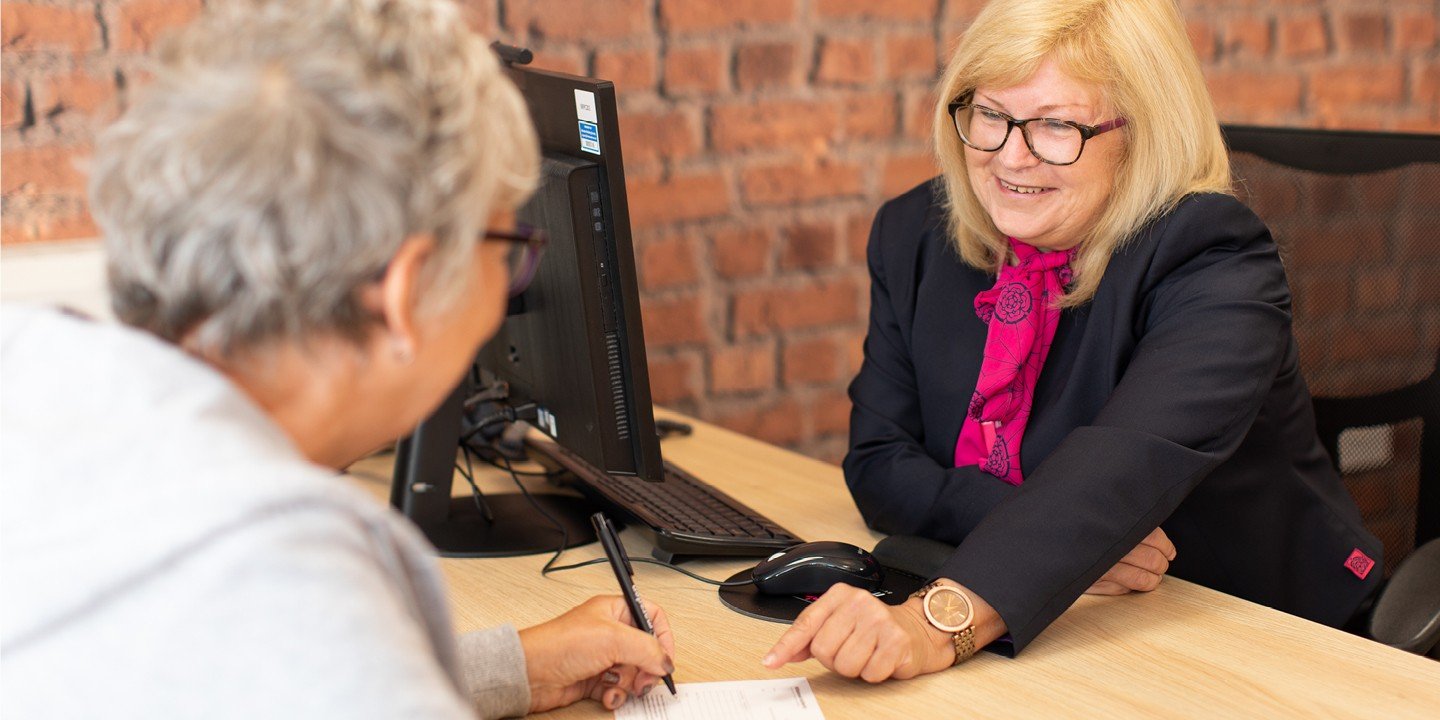 Smiling Marsden colleague chats with a customer in branch