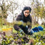 Woman works on community garden project after receiving funding from the Marsden Building Society Charitable Foundation.