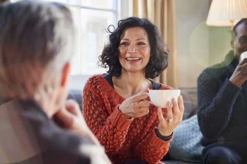 Smiling lady discusses opening a Fixed Rate Cash ISA with Marsden Building Society