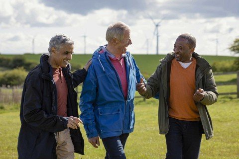 Group of friends enjoy a walk through the countryside discussing savings rates with the Marsden Building Society