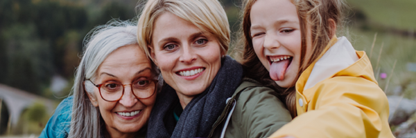 Mother, daughter and grandmother take a selfie on an outdoor walk