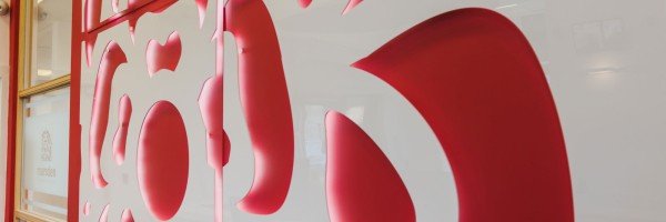 Close up of the interior of a Marsden Building Society office featuring the pink rose from their logo.