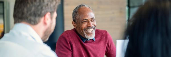 Business owner in a meeting knowing his savings are safe and secure with Marsden Building Society