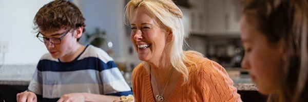 Mother enjoys dinner with her children after giving the Marsden her fixed rate ISA maturity instruction.