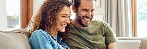 A couple looks at Marsden Building Society's online savings accounts from their home