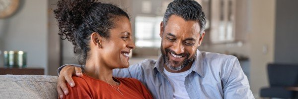 Pregnant couple sit together in their home after agreeing additional borrowing on their mortgage with Marsden Building Society