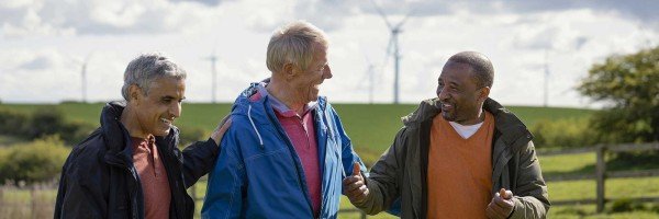 Group of friends enjoy a walk through the countryside discussing savings rates with the Marsden Building Society