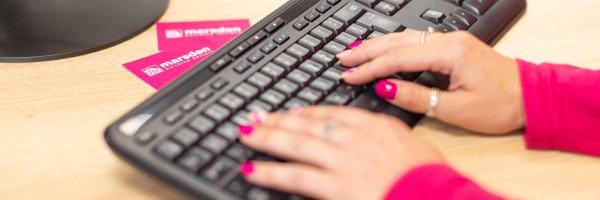 Marsden colleague on laptop browsing list of FAQs to help a customer