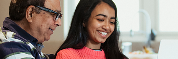Smiling grandfather and his granddaughter discussing insurance with the Marsden.