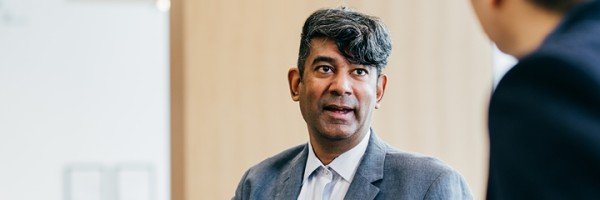 Businessman talks to his colleague about opening an account with Marsden Building Society.