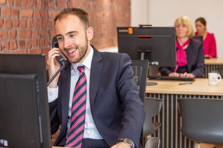 Smiling Marsden colleague on the phone to a customer