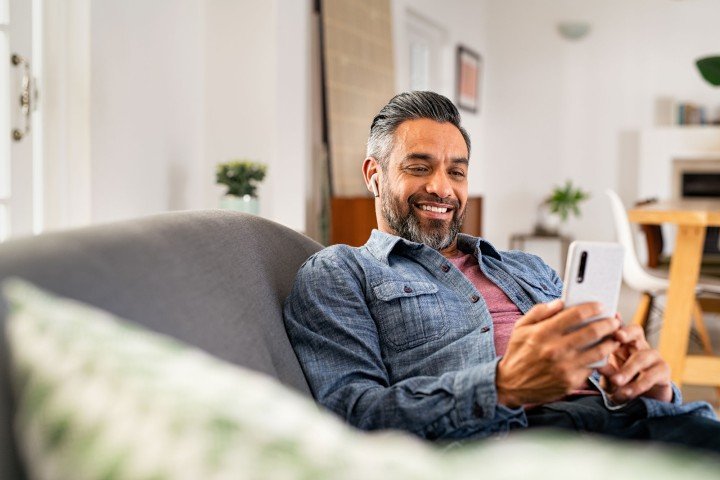 Man browses Marsden Building Society's Guernsey Expat Buy to Let product range on his smartphone