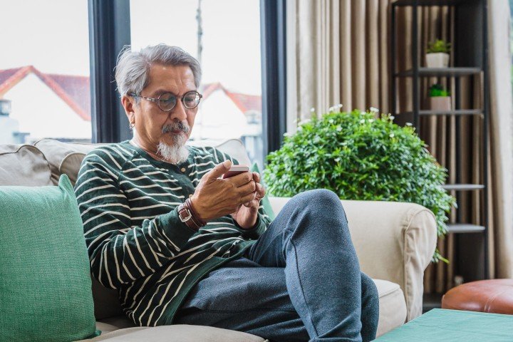 Mature man looks at RIO mortgage rates with Marsden Building Society in Guernsey.