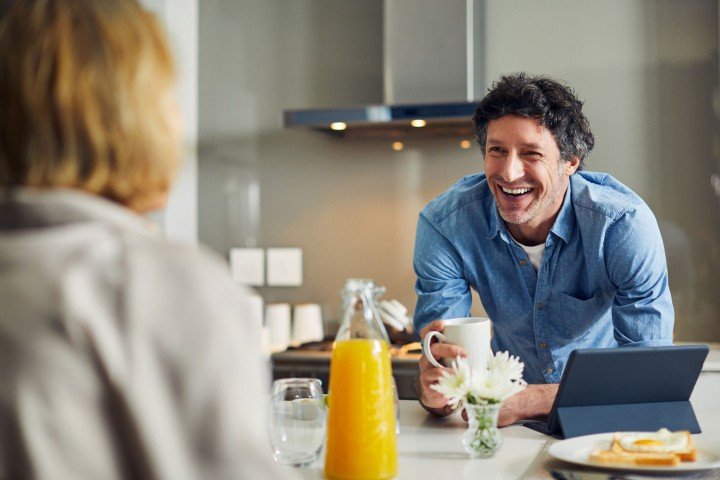 Smiling man enjoys a conversation with his wife after applying for an Expat Buy to Let mortgage with the Marsden intermediaries.