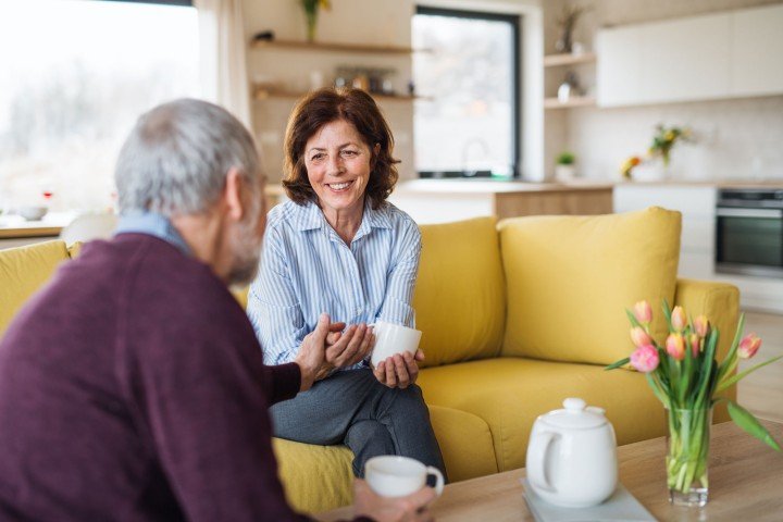 Mature couple sit together after sorting an Older Borrower mortgage with Marsden Building Society Intermediaries.