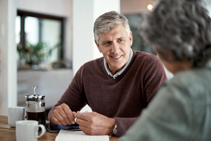 Man and woman sit at home discussing life planning