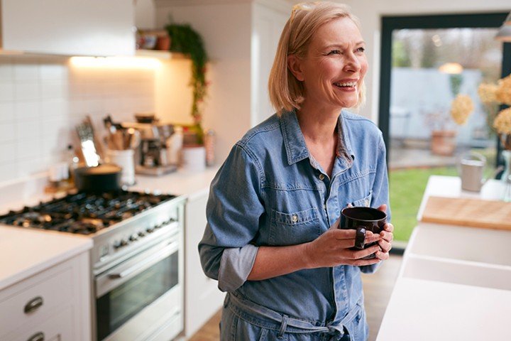 Woman enjoys a cup of coffee in her home after switching to a new mortgage product with the Marsden
