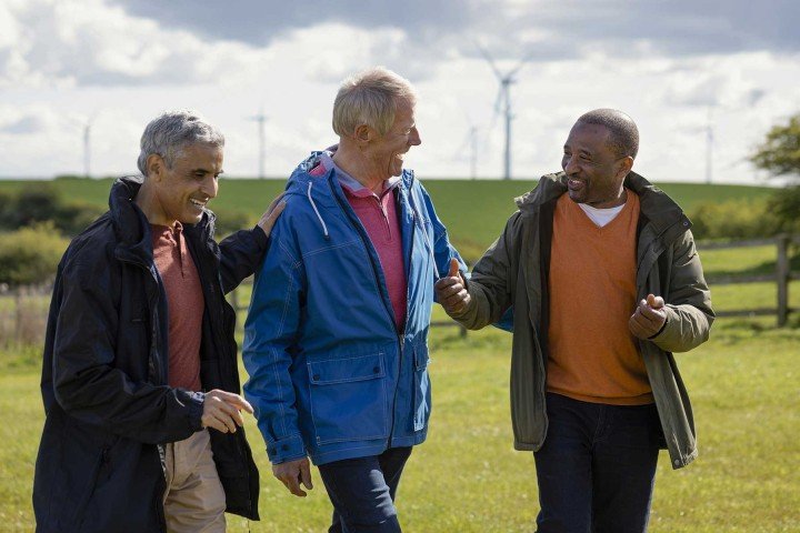 Group of friends enjoy a walk through the countryside discussing savings rates with the Marsden Building Society