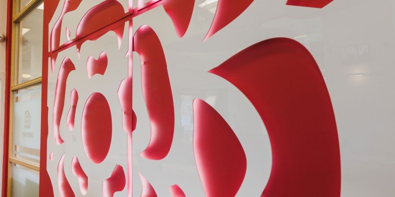Close up of the interior of a Marsden Building Society office featuring the pink rose from their logo.