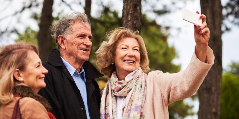 Group of mature friends enjoy the outdoors having assessed their options for a mortgage in retirement. 